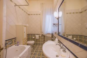 a bathroom with a tub and a sink and a toilet at CasAdòro in Arezzo +30 photos