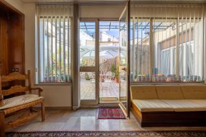 a living room with a couch and a large window at CasAdòro in Arezzo