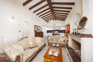 a living room with a couch and a table at Villa Emily in Ágios Stéfanos