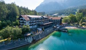 an aerial view of a resort on a river at Eibsee Hotel in Grainau