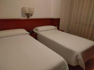 Posteľ alebo postele v izbe v ubytovaní Hotel Maycar