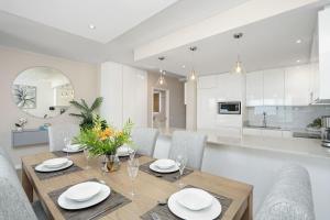 a dining room and kitchen with a table and chairs at Dolphin Beach H106 by Host Agents in Bloubergstrand