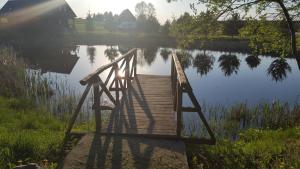 a wooden bridge over a body of water at Guest house Pīlādzis in Čornaja