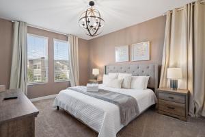 a bedroom with a bed and a chandelier at Gorgeous 6-bedroom house with private pool in Kissimmee