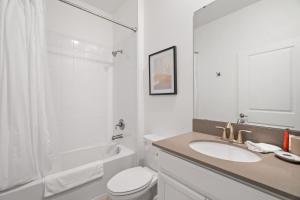 a bathroom with a sink and a toilet and a shower at Gorgeous 6-bedroom house with private pool in Kissimmee +51 photos