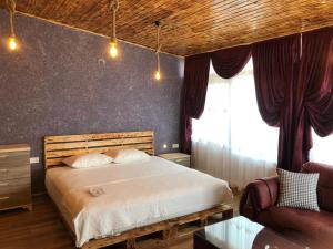 a bedroom with a large bed and a couch at Loft Suit Apart Otel in İskenderun