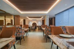 a restaurant with tables and chairs in a room at The Byke Stella Boutique Hotel Pan India Pure Veg Hotel Chain in Indore