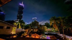 a tall building with lights on it at night at ORHO HOTEL BOUTIQUE PANAMA Tocumen Airport free shuttle highway round trip 15 minuts in Tocumen