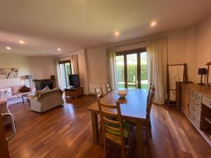 a living room with a dining table and a living room at House surrounded by mountain and nature in Riu de Cerdanya
