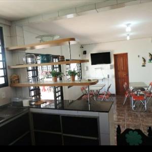 a kitchen with a table and a dining room at Hotel Araras in Manaus