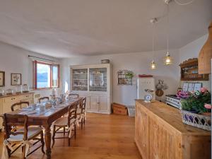 a kitchen and dining room with a table and chairs at La Casa di Mia - country house in Torri del Benaco +45 photos