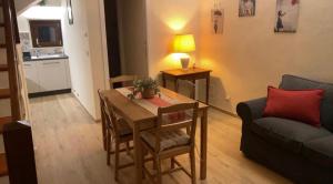 a living room with a table and a couch at Civico 1 in Cetona