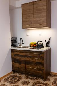 a kitchen with a sink and some fruit on a counter at Pokoje gościnne KOGA in Nickelswalde +9 photos