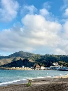 a view of a beach with a mountain in the background at Tamuda golf in Cabo Negro