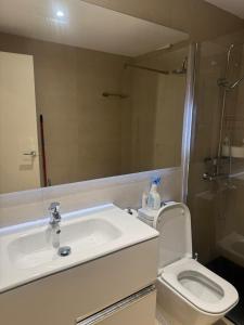 a bathroom with a sink and a toilet and a mirror at Euro 27 in Madrid