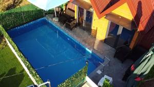 an overhead view of a swimming pool next to a house at AM Pyramid resting in Visoko