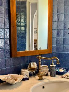 a bathroom counter with a sink and a mirror at Aloni House in Triandáros +16 photos