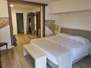 a bedroom with a large white bed and a mirror at 2bebike in Manerba del Garda
