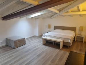 a bedroom with a large bed and a wooden floor at 2bebike in Manerba del Garda