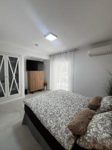 a bedroom with a large bed and a flat screen tv at Apartman Leoni 1 linea in Salou