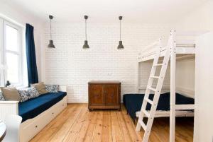 a bedroom with a bunk bed and a ladder at Apartment Sopot I in Sopot