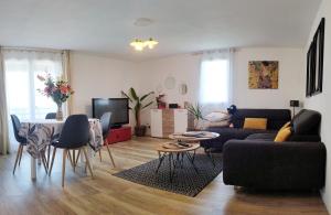 a living room with a couch and a table at Au levant de Marie in Gaillac