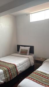Voodi või voodid majutusasutuse Alegria s House Cusco toas