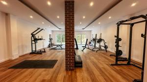 a gym with several tread machines and a brick pillar at Agroturystyka Kaczor nad jeziorem in Męcidół