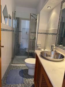 a bathroom with a sink and a toilet and a shower at Edificio Es Pujols 10 ALTA TURISTICA in Es Pujols