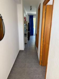 a hallway with a tile floor in a house at Edificio Es Pujols 10 ALTA TURISTICA in Es Pujols