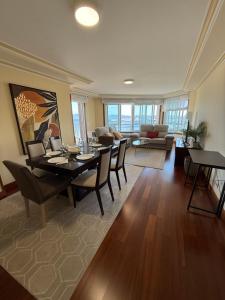 a dining room and living room with a table and chairs at Adefer Isamar in Sanxenxo