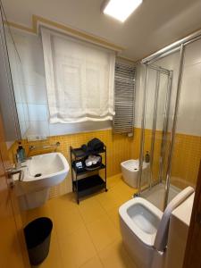 a bathroom with two sinks and a toilet and a shower at Adefer Isamar in Sanxenxo +43 photos