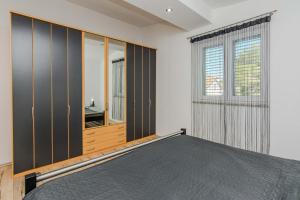 a bedroom with a bed and a window at Apartmani Sanja in Vir +27 photos