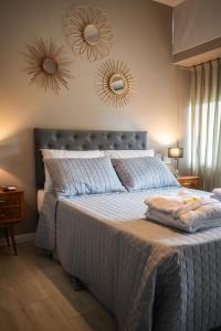 a bedroom with a bed with two mirrors on the wall at Armonium Airport in Ezeiza