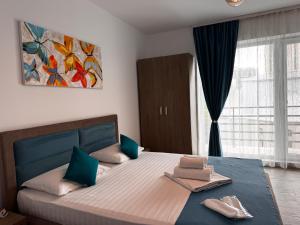 a bedroom with a bed with two towels on it at Pensiunea CASID in Eforie Nord +69 photos