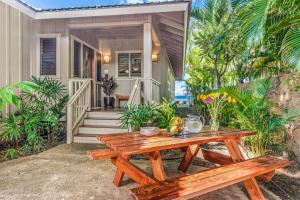 a wooden picnic table in front of a house at 3BD Estate Home at Puako Bay (10D) in Waikoloa