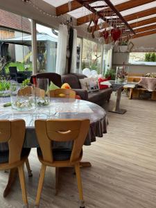 a dining room with a table and a couch at Gästehaus Jutta / Pension Link in Fladungen