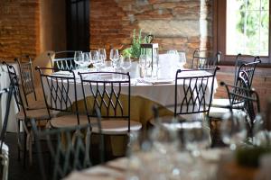a table with chairs and wine glasses on it at Tenuta Molino dei Sassi in Zevio