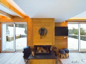 a living room with a fireplace in a house at Le Petit Paradis, Spa-Sauna and Gym in Gérardmer