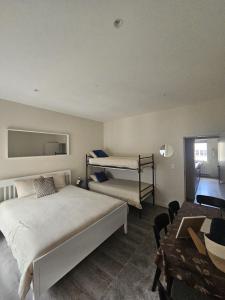a bedroom with two bunk beds and a table at L' Gante in Ghent +6 photos