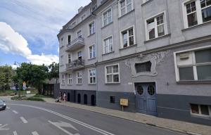 a gray building on the side of a street at Apartment Sopot I in Sopot