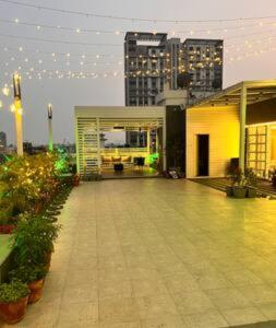 a building with a courtyard with plants and buildings at Twilight Grove - Rooftop - AC - Wi-Fi - 2BHK in Kolkata