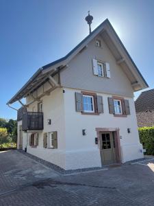 a large white building with a roof at Ferienhaus Pflugwirts in Oberkirch