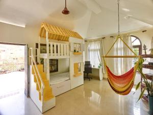 a room with a bed and a hammock in it at Ushas Homestay in Trivandrum