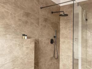a bathroom with a shower with a glass door at Agroturystyka Kaczor nad jeziorem in Męcidół +56 photos