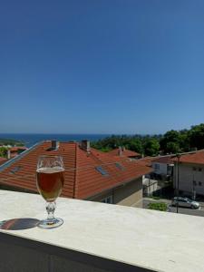 a glass of wine sitting on top of a ledge at Magi Sunrise in Balchik