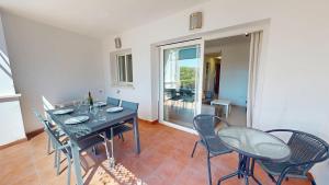 a dining room with a table and chairs and a balcony at Casa Indico J-Murcia Holiday Rentals Property in Sucina