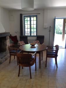 a living room with a table and chairs and a fireplace at Centre Les Labadous in Rennes-le-Château +65 photos