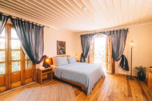 a bedroom with a bed with blue drapes at Jade Residence in Oludeniz