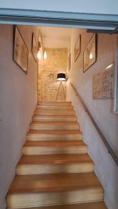 a staircase with wooden steps in a building at Hôtel L'Herbier d'Orange - Accueil Vélo in Orange